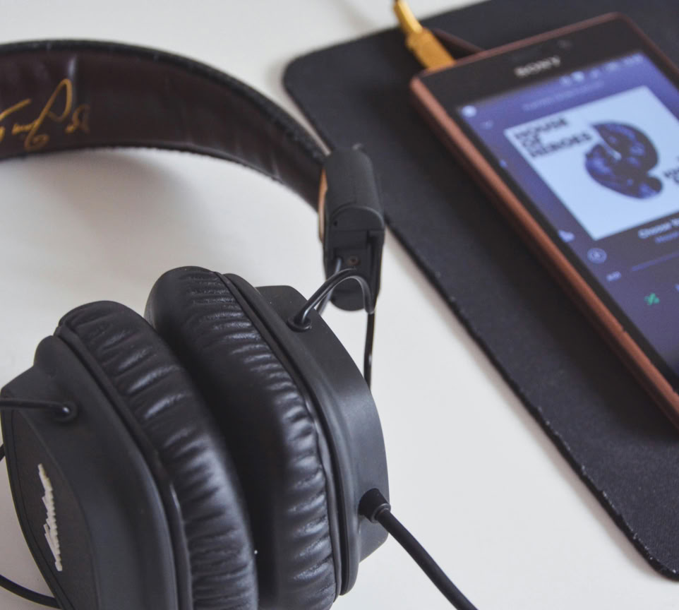 Black Corded Headphones Beside Sony Android Smartphone