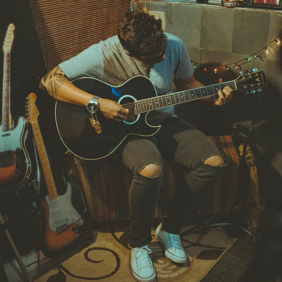 Person Playing Guitar